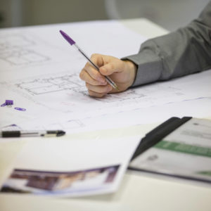 Picture of architectural designer checking drawings Malton office, Yorkshire.